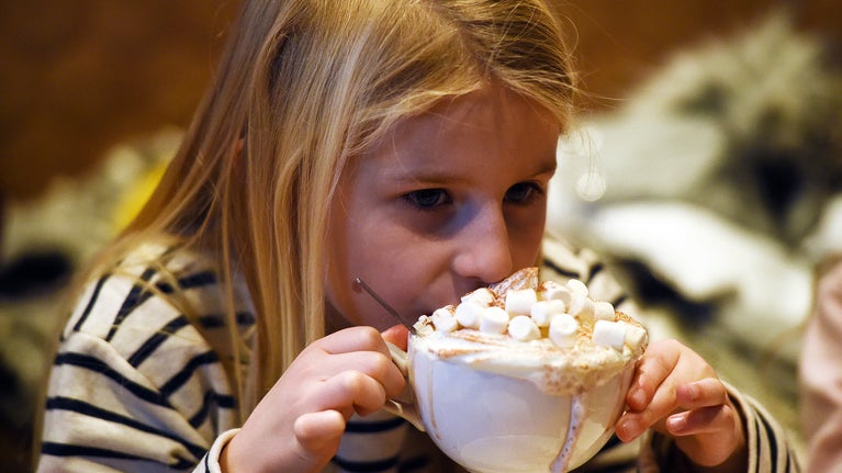 Girl drinking a hot chocolate with marshmallows